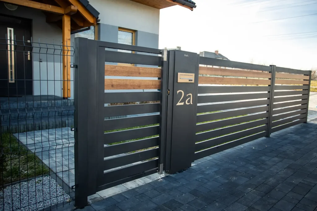 Ogrodzenie czarno-drewnopodobne z bramą przesuwną - Realizacja w Pisarzowicach, woj. śląskie - zdjęcie 2